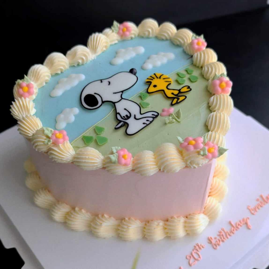 Heart-shaped cartoon-inspired cake topped with hand-piped buttercream roses, healthy low-calorie floral birthday cake