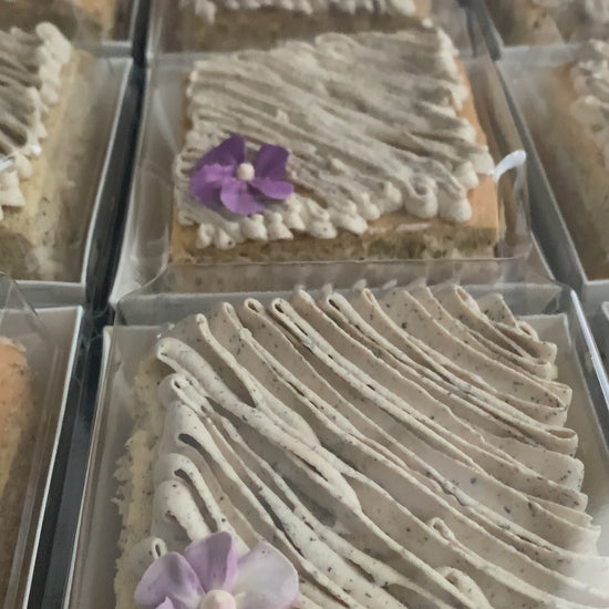Earl Grey tea cake with swirled speckled buttercream and purple violet flower in clear gift box, healthy low-sugar cake Singapore