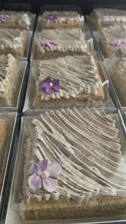 Earl Grey tea cake with swirled speckled buttercream and purple violet flower in clear gift box, healthy low-sugar cake Singapore