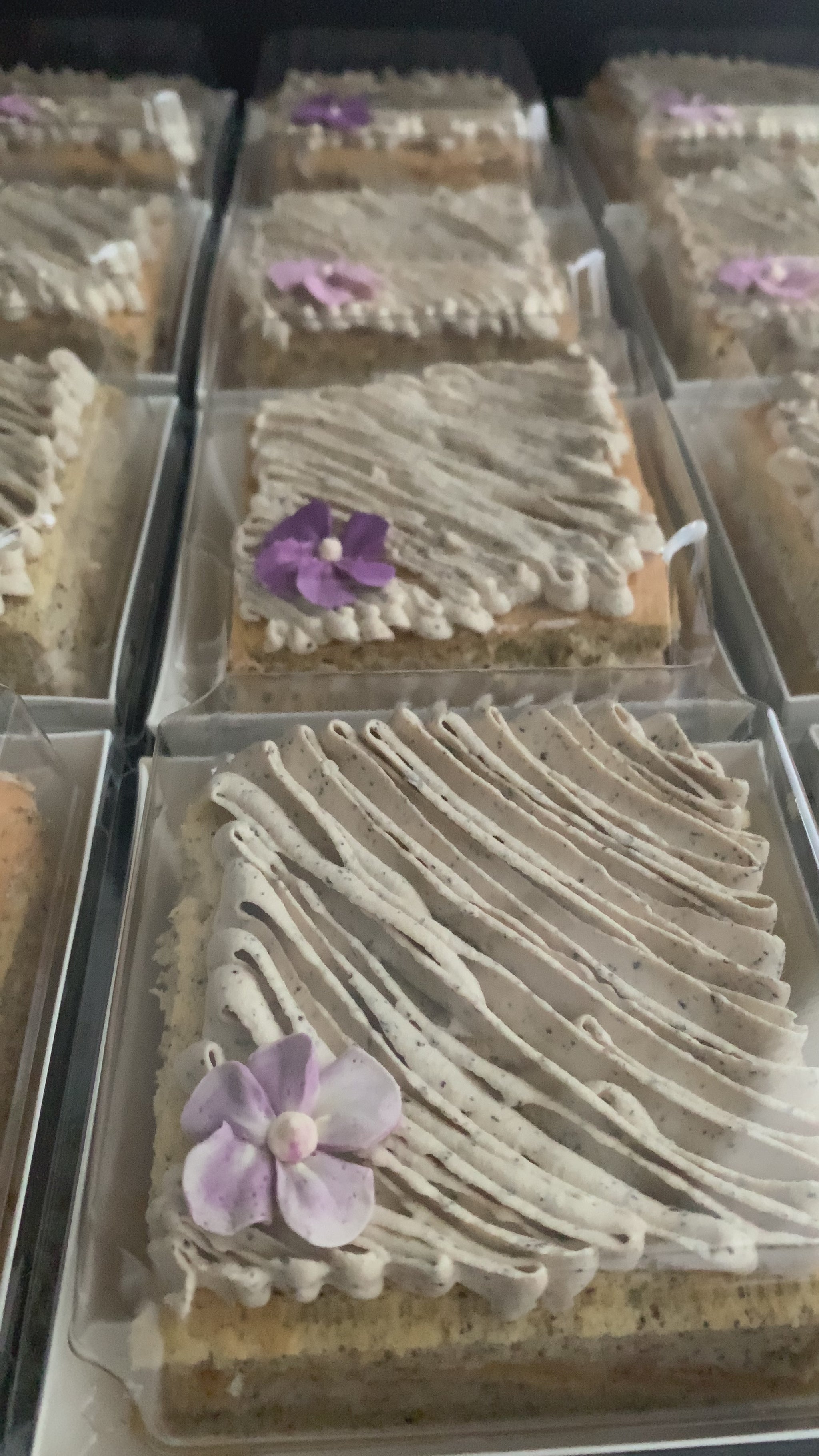 Earl Grey tea cake with swirled speckled buttercream and purple violet flower in clear gift box, healthy low-sugar cake Singapore