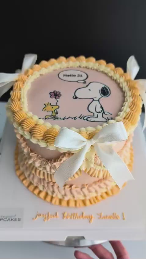 Round vintage Snoopy cake topped with hand-piped buttercream roses, healthy low-calorie floral birthday cake